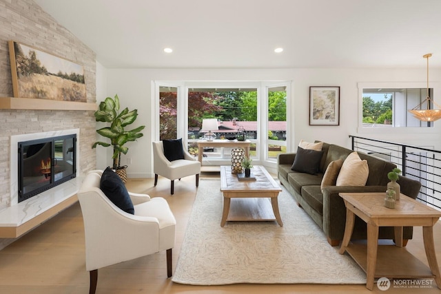 7502 117th Ave NE, Kirkland, WA 98033 - living area featuring plenty of natural light, wood finished floors, a large fireplace, and recessed lighting