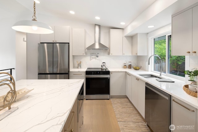 7502 117th Ave NE, Kirkland, WA 98033 - kitchen featuring appliances with stainless steel finishes, wall chimney range hood, decorative backsplash, light wood-type flooring, and decorative light fixtures