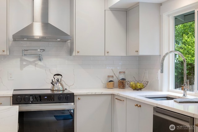 7502 117th Ave NE, Kirkland, WA 98033 - kitchen with appliances with stainless steel finishes, wall chimney range hood, white cabinetry, tasteful backsplash, and light stone counters