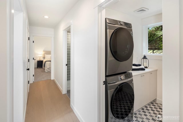 7502 117th Ave NE, Kirkland, WA 98033 - washroom with stacked washer / dryer, light wood finished floors, and recessed lighting