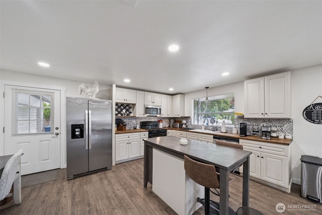 2010 Tacoma Rd, Puyallup, WA 98371 - kitchen featuring appliances with stainless steel finishes, decorative backsplash, white cabinetry, and recessed lighting