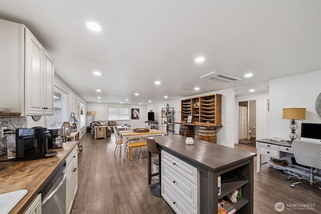 2010 Tacoma Rd, Puyallup, WA 98371 - kitchen with butcher block counters, stainless steel dishwasher, recessed lighting, open floor plan, and white cabinets