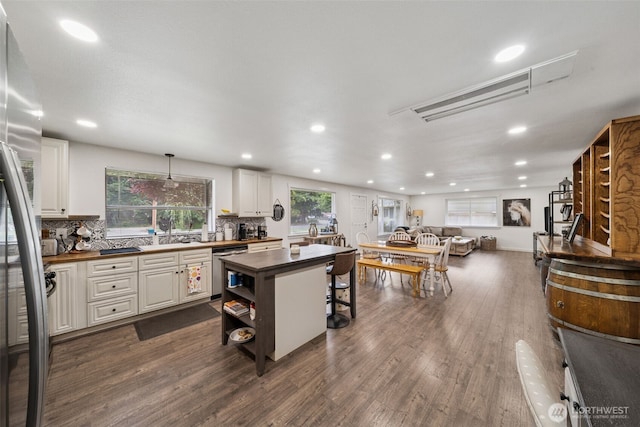 2010 Tacoma Rd, Puyallup, WA 98371 - kitchen with white cabinetry, stainless steel appliances, backsplash, dark wood-style floors, and recessed lighting