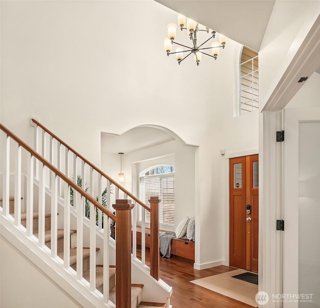 414 10th St S, Kirkland, WA 98033 - entryway featuring a chandelier, wood finished floors, a high ceiling, and stairs