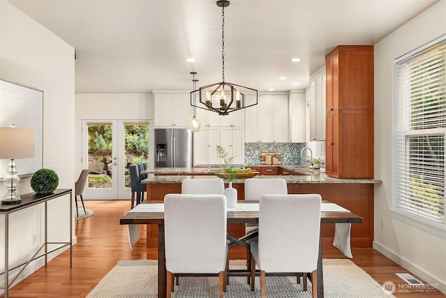 414 10th St S, Kirkland, WA 98033 - dining space with light wood finished floors, a chandelier, plenty of natural light, french doors, and recessed lighting