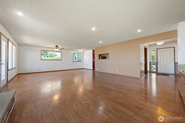 103 Crest Dr, Ephrata, WA 98823 - unfurnished living room with a textured ceiling, ceiling fan, wood finished floors, healthy amount of natural light, and recessed lighting