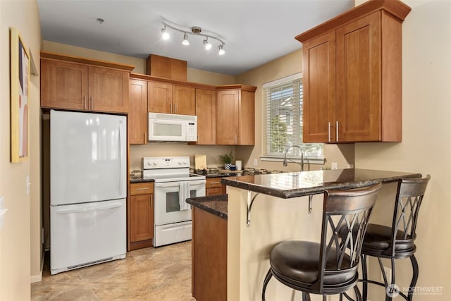 6125 Kennedy Ave SE Unit F7, Auburn, WA 98092 - kitchen featuring white appliances, a peninsula, and brown cabinets