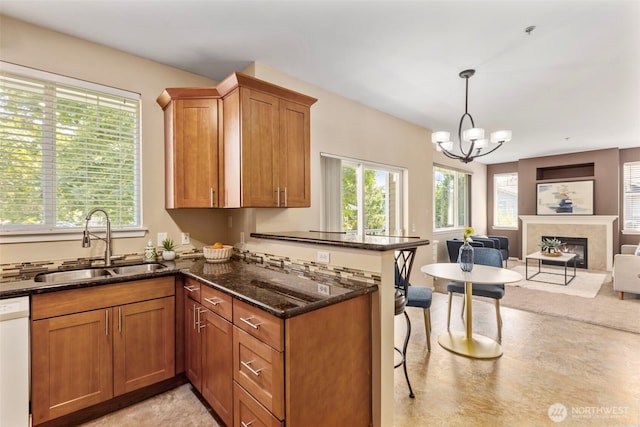 6125 Kennedy Ave SE Unit F7, Auburn, WA 98092 - kitchen with a peninsula, open floor plan, dishwasher, dark stone countertops, and brown cabinets