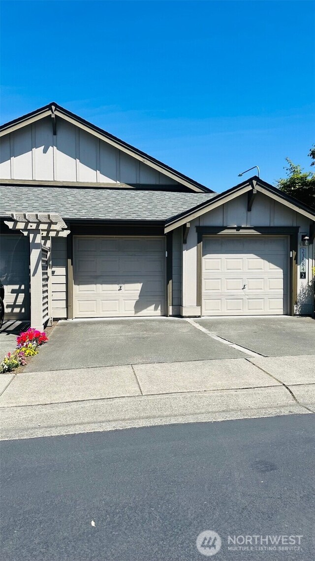 23884 NE 112th Cir Unit 2, Redmond, WA 98053 - view of front facade featuring board and batten siding, concrete driveway, and an attached garage