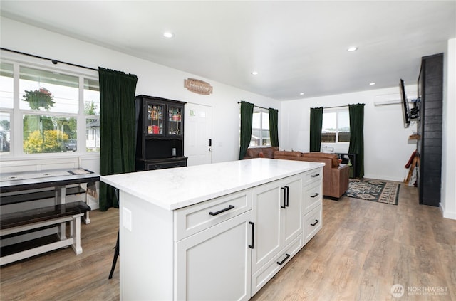 235 Morton St, Sumas, WA 98295 - kitchen featuring white cabinetry, light wood finished floors, a kitchen island, recessed lighting, and open floor plan
