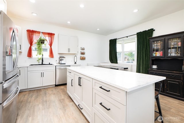 235 Morton St, Sumas, WA 98295 - kitchen featuring stainless steel appliances, light wood-style flooring, a kitchen island, recessed lighting, and a kitchen bar