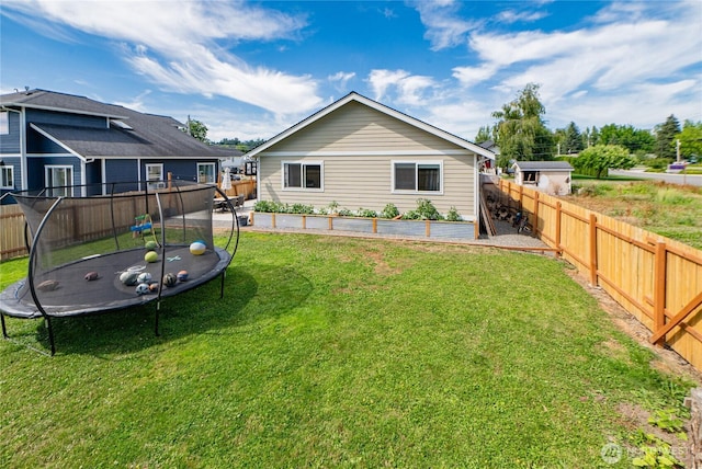 235 Morton St, Sumas, WA 98295 - back of house with a trampoline and a fenced backyard