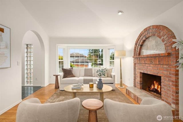 1417 232nd Pl SW, Bothell, WA 98021 - living area featuring wood finished floors, a brick fireplace, and arched walkways