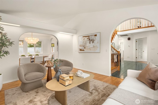 1417 232nd Pl SW, Bothell, WA 98021 - living room featuring arched walkways, wood finished floors, stairway, and a chandelier