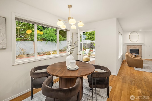 1417 232nd Pl SW, Bothell, WA 98021 - dining space featuring a chandelier, light wood finished floors, and a fireplace
