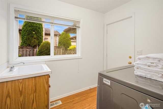 1417 232nd Pl SW, Bothell, WA 98021 - washroom with light wood-style flooring and washer / clothes dryer
