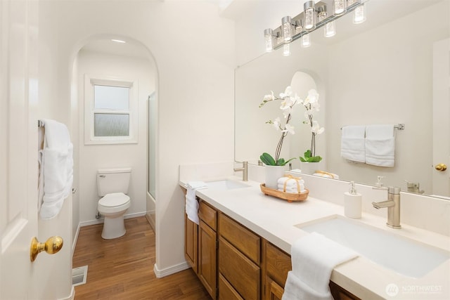 1417 232nd Pl SW, Bothell, WA 98021 - bathroom featuring double vanity, wood finished floors, and shower / bath combination with glass door