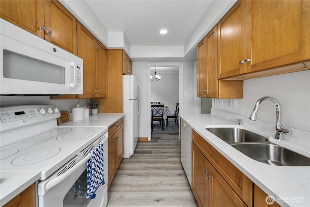 4840 E B St, Tacoma, WA 98404 - kitchen featuring white appliances, brown cabinets, light wood-type flooring, light countertops, and recessed lighting