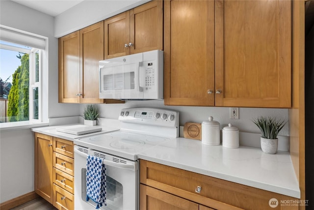 4840 E B St, Tacoma, WA 98404 - kitchen featuring white appliances, light countertops, and brown cabinets