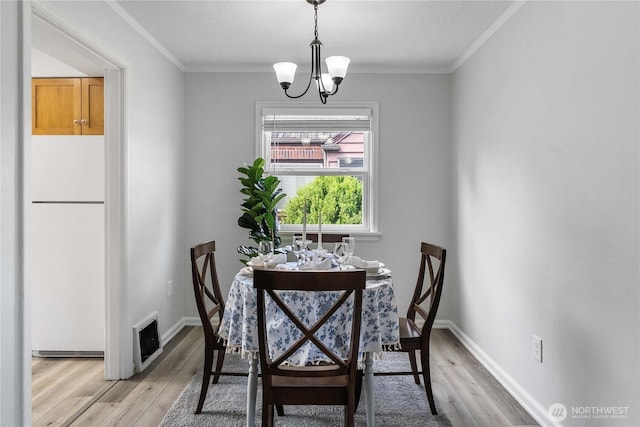 4840 E B St, Tacoma, WA 98404 - dining area featuring a chandelier, light wood-type flooring, and ornamental molding