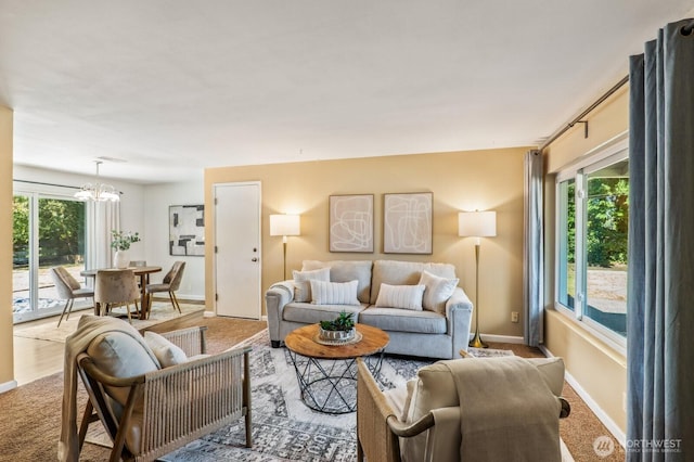 3923 NE 22nd Pl, Renton, WA 98056 - carpeted living room with baseboards and a chandelier