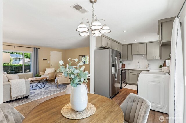 3923 NE 22nd Pl, Renton, WA 98056 - dining area featuring a chandelier, light wood-style flooring, and recessed lighting