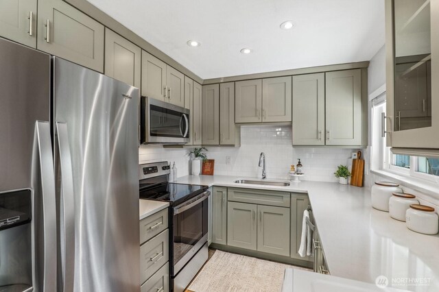 3923 NE 22nd Pl, Renton, WA 98056 - kitchen with appliances with stainless steel finishes, tasteful backsplash, light countertops, recessed lighting, and gray cabinetry