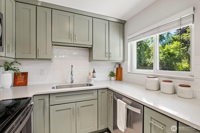 3923 NE 22nd Pl, Renton, WA 98056 - kitchen featuring stainless steel appliances, gray cabinetry, tasteful backsplash, and light countertops