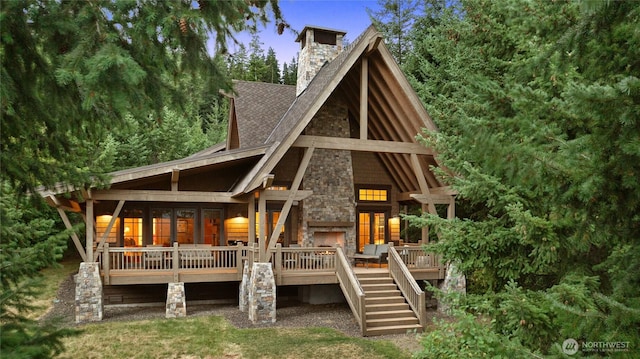 80 Queens Loop, Cle Elum, WA 98922 - back of house with stone siding, a shingled roof, a deck, a chimney, and stairs