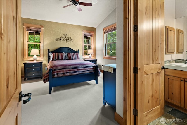 80 Queens Loop, Cle Elum, WA 98922 - carpeted bedroom featuring vaulted ceiling, a textured wall, and ceiling fan