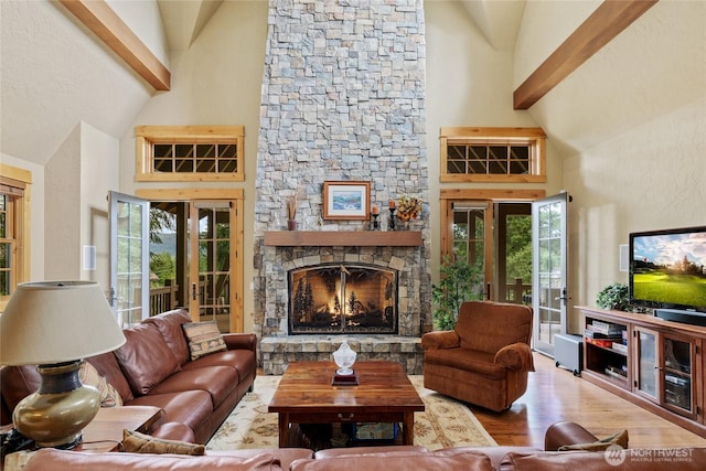 80 Queens Loop, Cle Elum, WA 98922 - living room with high vaulted ceiling, a stone fireplace, wood finished floors, healthy amount of natural light, and beam ceiling
