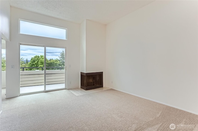 7435 Old Redmond Rd Unit 325, Redmond, WA 98052 - unfurnished living room featuring carpet and a high ceiling