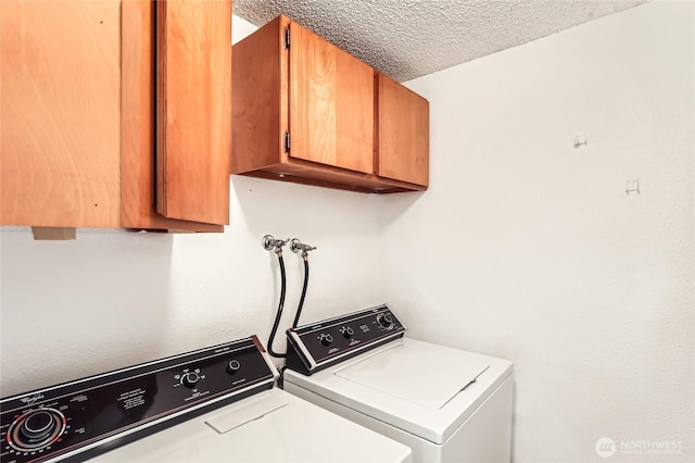 7435 Old Redmond Rd Unit 325, Redmond, WA 98052 - laundry area with cabinet space, separate washer and dryer, and a textured ceiling