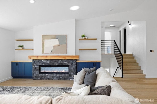 2403 E Hemmi Rd, Bellingham, WA 98226 - living area featuring light wood-type flooring, stairway, recessed lighting, a fireplace, and lofted ceiling