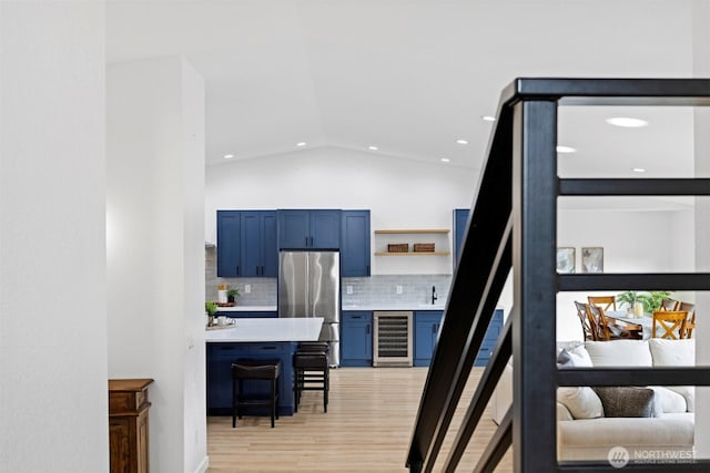 2403 E Hemmi Rd, Bellingham, WA 98226 - staircase featuring wine cooler, wood finished floors, recessed lighting, and lofted ceiling