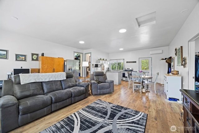 2403 E Hemmi Rd, Bellingham, WA 98226 - living area with attic access, light wood-style floors, a wall unit AC, and recessed lighting