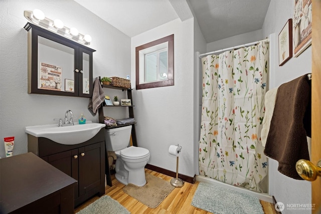 2403 E Hemmi Rd, Bellingham, WA 98226 - full bath with vanity, wood finished floors, and a shower with curtain