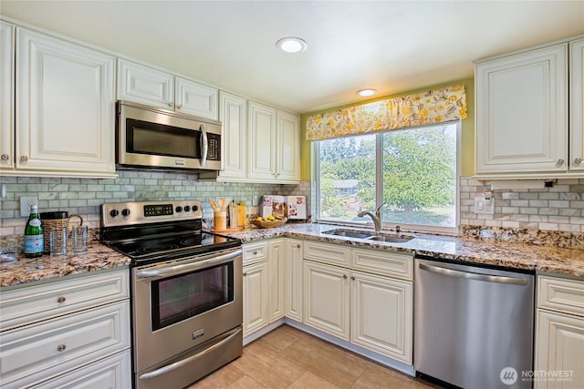5428 172nd St SW, Lynnwood, WA 98037 - kitchen with appliances with stainless steel finishes, backsplash, light stone countertops, white cabinetry, and recessed lighting