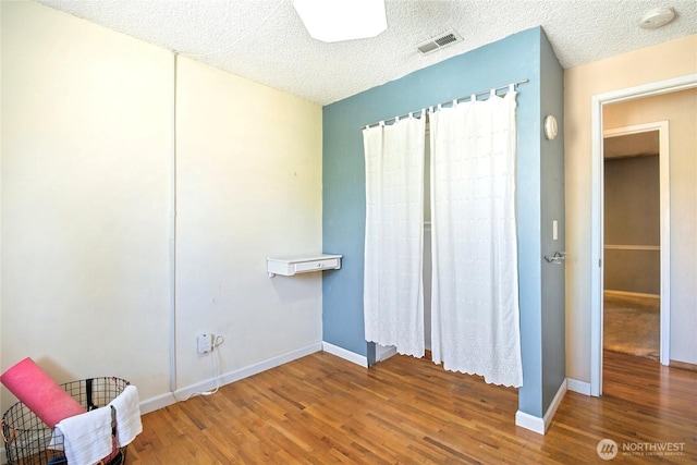 5428 172nd St SW, Lynnwood, WA 98037 - unfurnished bedroom featuring wood finished floors and a textured ceiling
