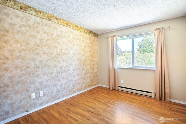 5428 172nd St SW, Lynnwood, WA 98037 - spare room with a baseboard radiator, wood finished floors, and a textured ceiling