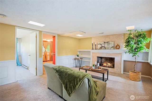 5428 172nd St SW, Lynnwood, WA 98037 - carpeted living area featuring a premium fireplace, wainscoting, and baseboard heating
