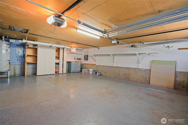 5428 172nd St SW, Lynnwood, WA 98037 - garage featuring a garage door opener and strapped water heater
