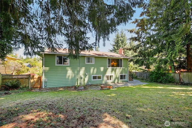 5428 172nd St SW, Lynnwood, WA 98037 - rear view of property with a fenced backyard, a chimney, and a patio