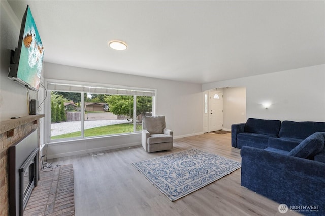 5502 82nd Street Ct E, Puyallup, WA 98371 - living area with a brick fireplace and wood finished floors