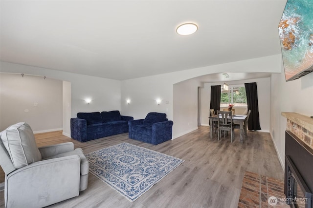 5502 82nd Street Ct E, Puyallup, WA 98371 - living room with light wood finished floors, arched walkways, and a fireplace