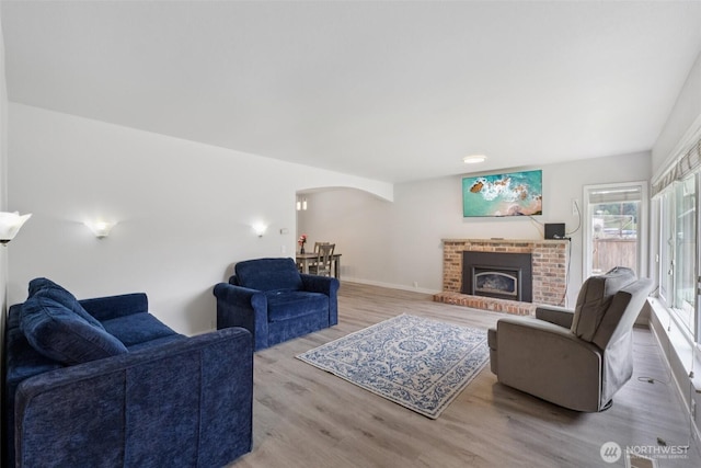 5502 82nd Street Ct E, Puyallup, WA 98371 - living area featuring arched walkways, wood finished floors, and a brick fireplace