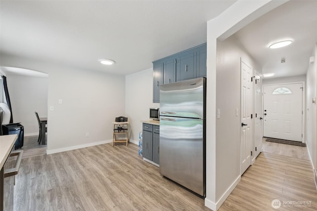 5502 82nd Street Ct E, Puyallup, WA 98371 - kitchen with appliances with stainless steel finishes, light wood-style flooring, blue cabinets, and light countertops