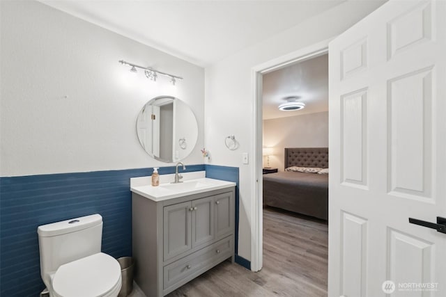 5502 82nd Street Ct E, Puyallup, WA 98371 - ensuite bathroom featuring vanity, wood finished floors, and a wainscoted wall