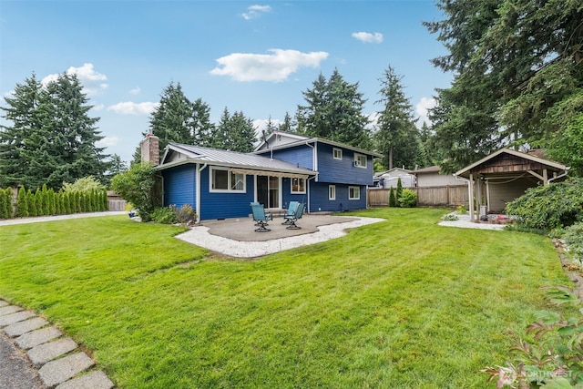 5502 82nd Street Ct E, Puyallup, WA 98371 - back of property featuring a patio area, a chimney, a metal roof, and a standing seam roof