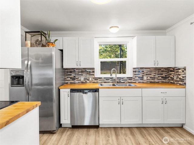 8839 S Yakima Ave, Tacoma, WA 98444 - kitchen featuring wooden counters, stainless steel appliances, light wood-style flooring, backsplash, and ornamental molding